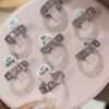 Anel Feminino Aço Inoxidável Prata Cravejado de Zircônias Rosa - Meia Aliança Antialérgico